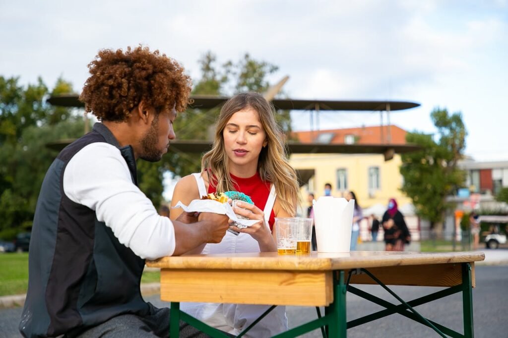 Friends eating burgers on street in daytime